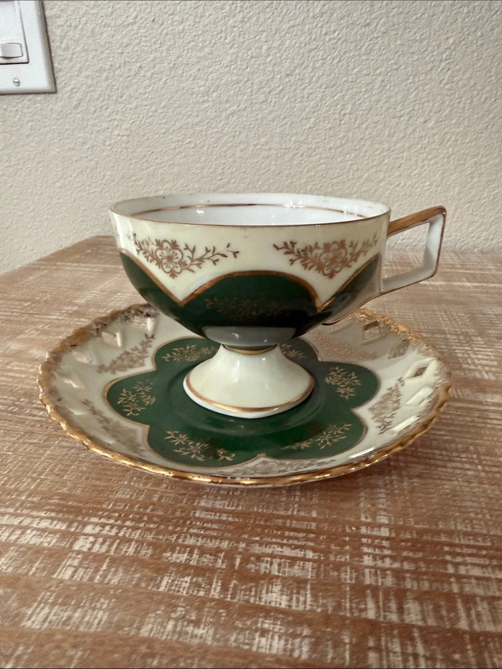 Vintage Japanese green and gold reticulated teacup, and pierced saucer.